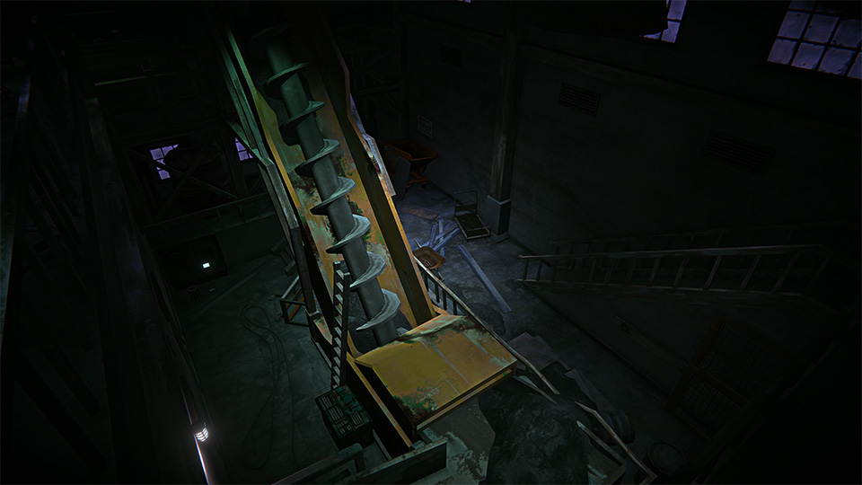 Dark interior of an industrial building with a large yellow mining machine with spiral blades, amidst scattered debris.